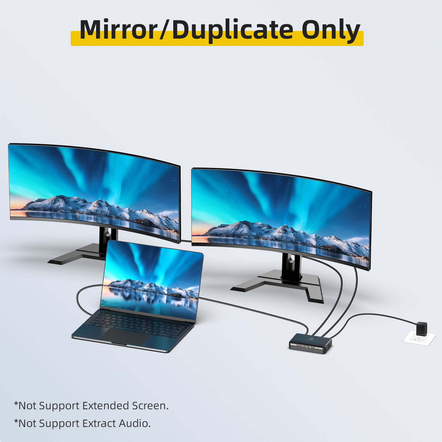 Mirror/Duplicate function: Two computer monitors and a laptop displaying the same mountainous landscape.